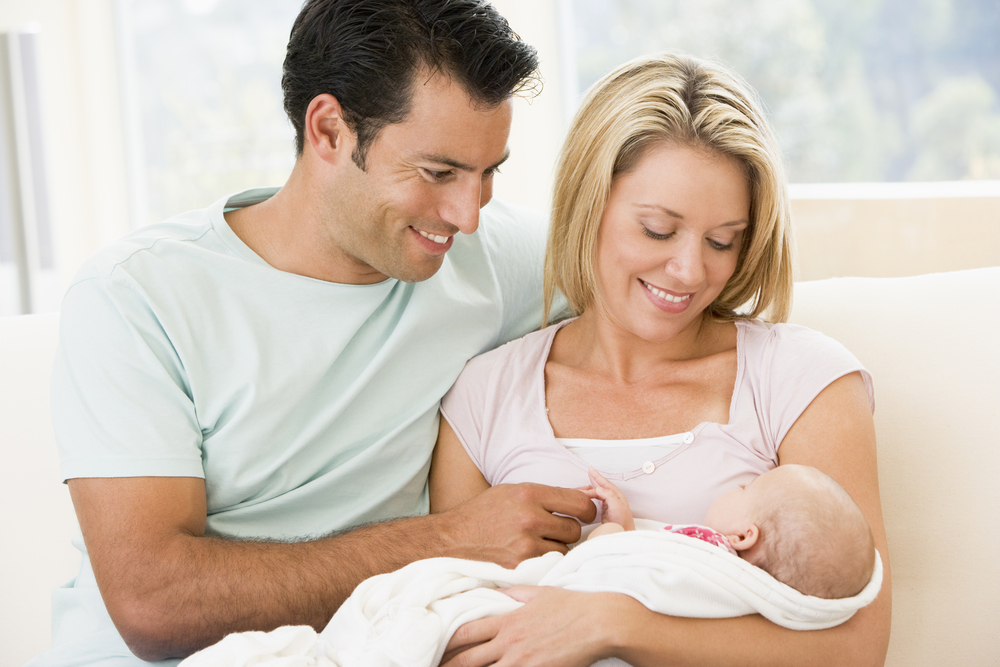 Two parents on parental leave in Alberta enjoying time with their baby