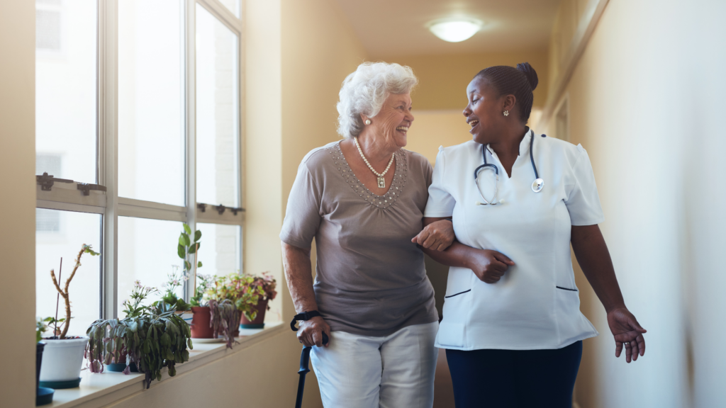 Long-term care worker walking alongside resident